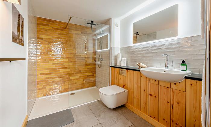 The shower room for your eco stay has a generous walk-in deluge shower and glass screen